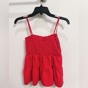 red top that is more fitted at the top and flowy at the bottom